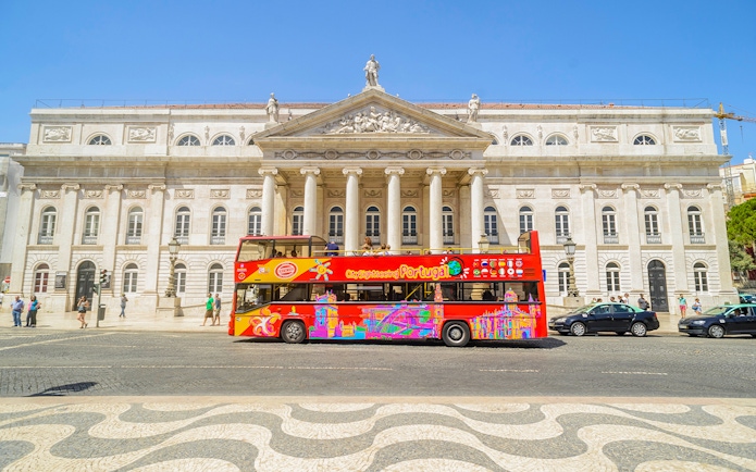 Hop-On Hop-Off Lisbon bus in front of Lisbon's National Theatre.