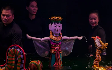 Performers with puppets at Thang Long Water Puppet Show in Hanoi, Vietnam.