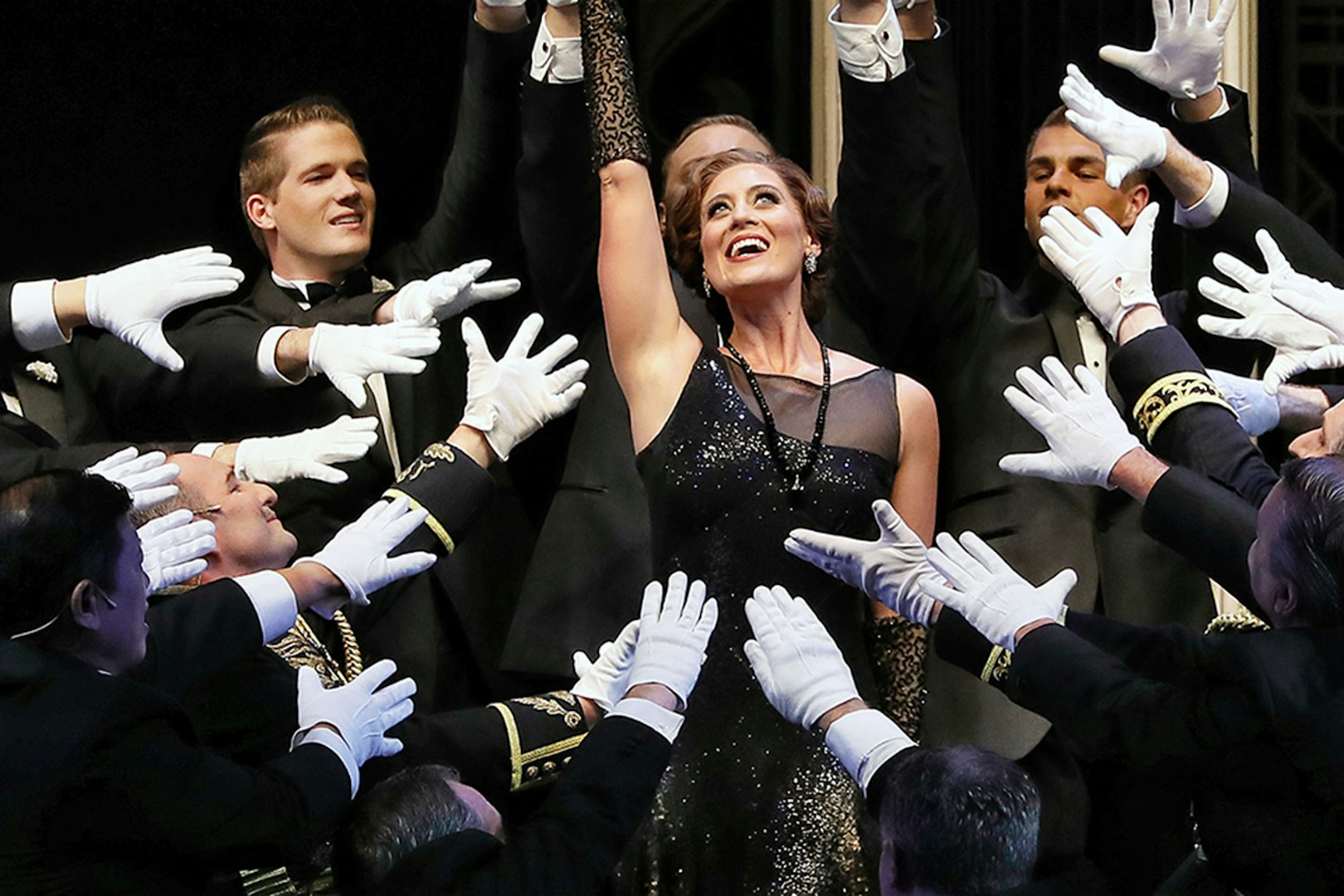 Theatrical scene from The Merry Widow in Sydney with performers in formal attire.