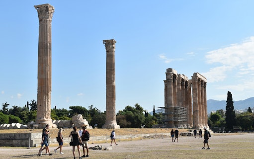 Temple of Olympian Zeus ruins with tourists walking, Athens.