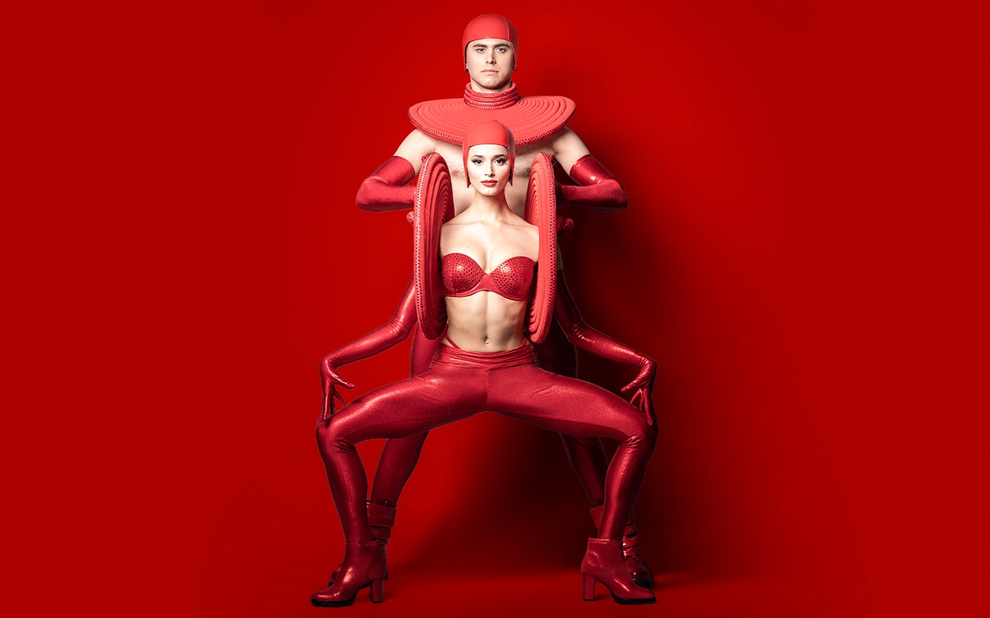 Performers in red costumes at FALLING | IN LOVE Grand Show, Friedrichstadt Palast.