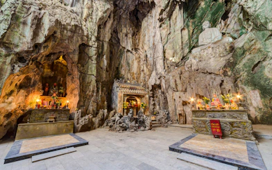 Shrine inside Huyền Không Cave with altars and statues, Marble Mountains, Đà Nẵng.