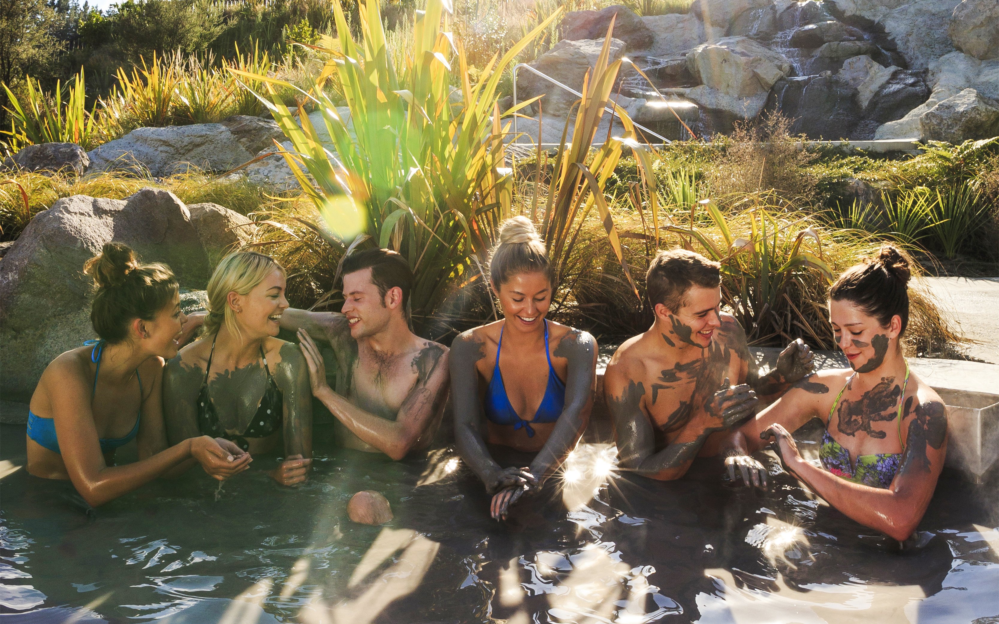 Group enjoying Hell's Gate mud bath in a natural setting.