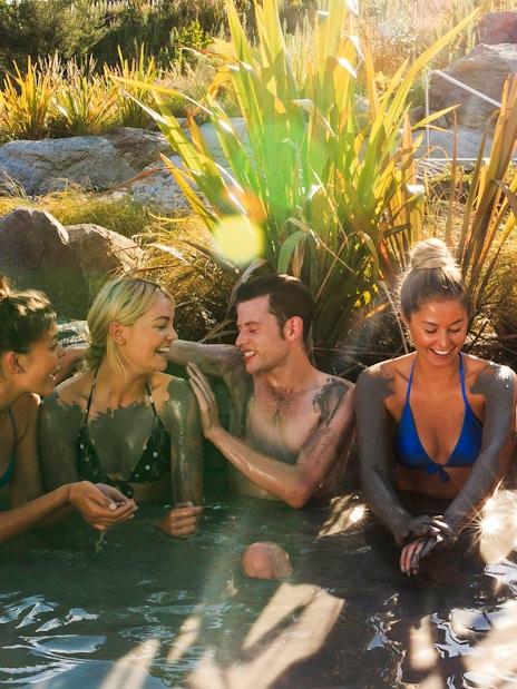 Group enjoying Hell's Gate mud bath in a natural setting.