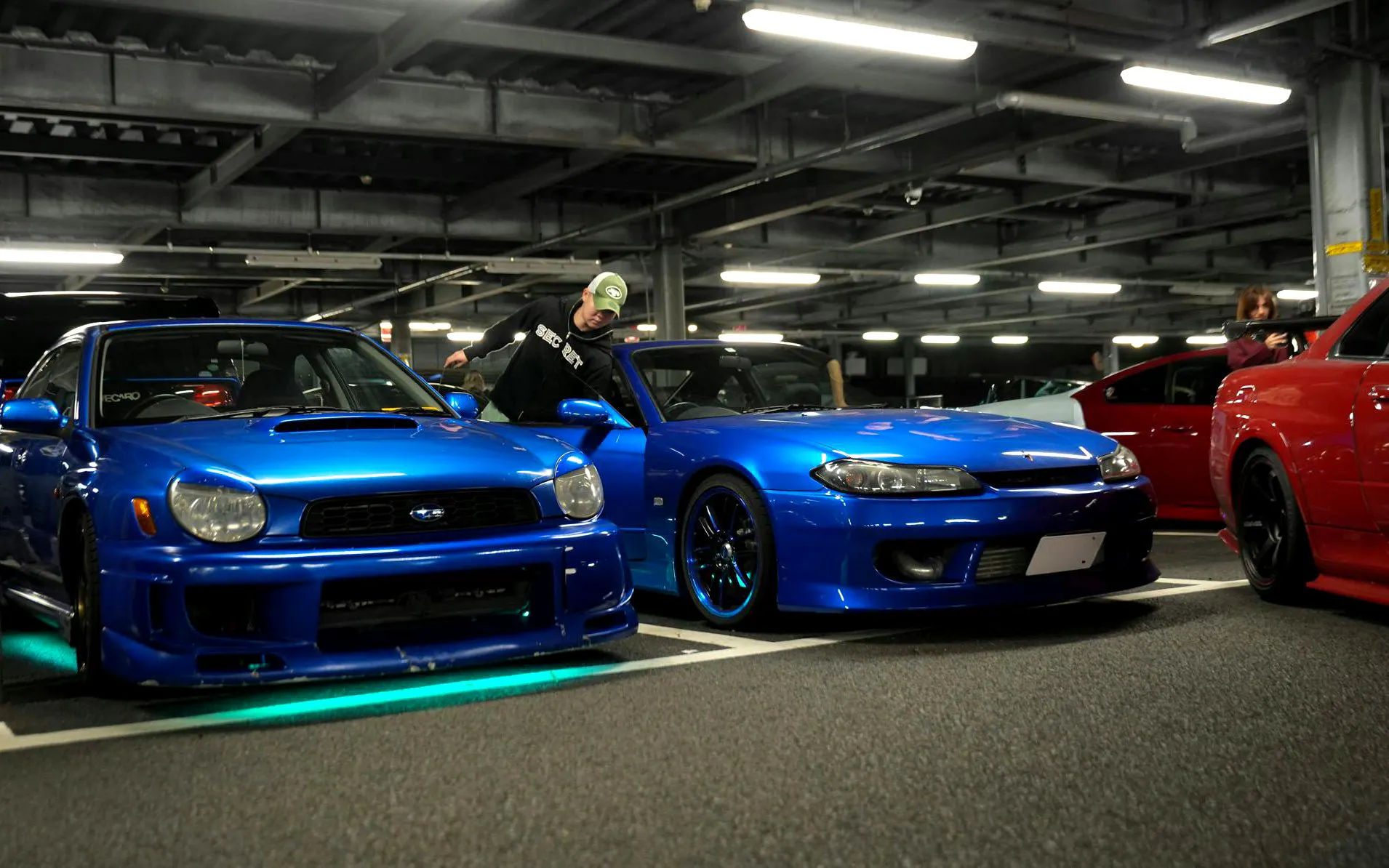 Blue sports cars at JDM Tokyo car meetup night tour in Tokyo parking garage.