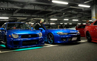 Blue sports cars at JDM Tokyo car meetup night tour in Tokyo parking garage.