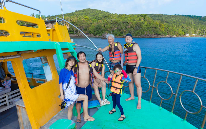 Tourists in life jackets on a boat during a 3-island trip in Phu Quoc, Vietnam.