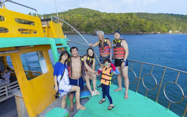 Tourists in life jackets on a boat during a 3-island trip in Phu Quoc, Vietnam.