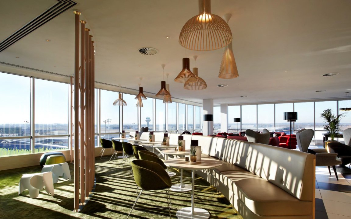 Plaza Premium Lounge seating area with airport view, North Terminal, London Gatwick Airport.
