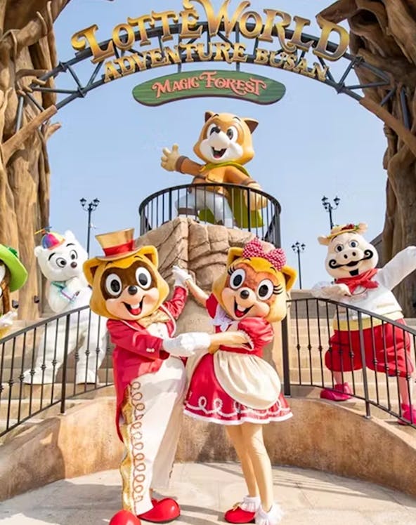 Characters in costumes at Lotte World Adventure, Busan's Magic Forest entrance.