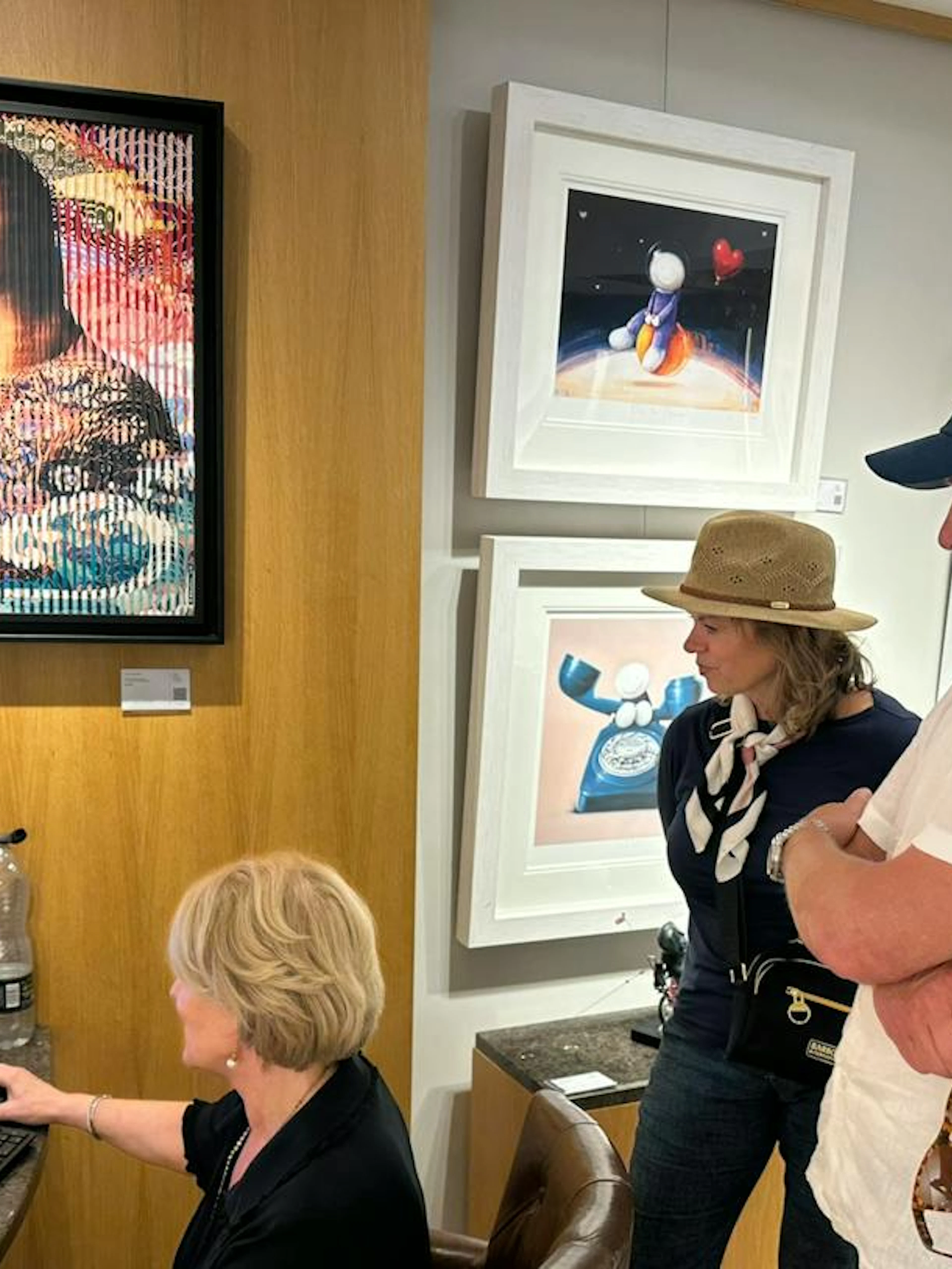 Art gallery visitors viewing paintings during North Cotswolds antiques shopping tour, Oxford.