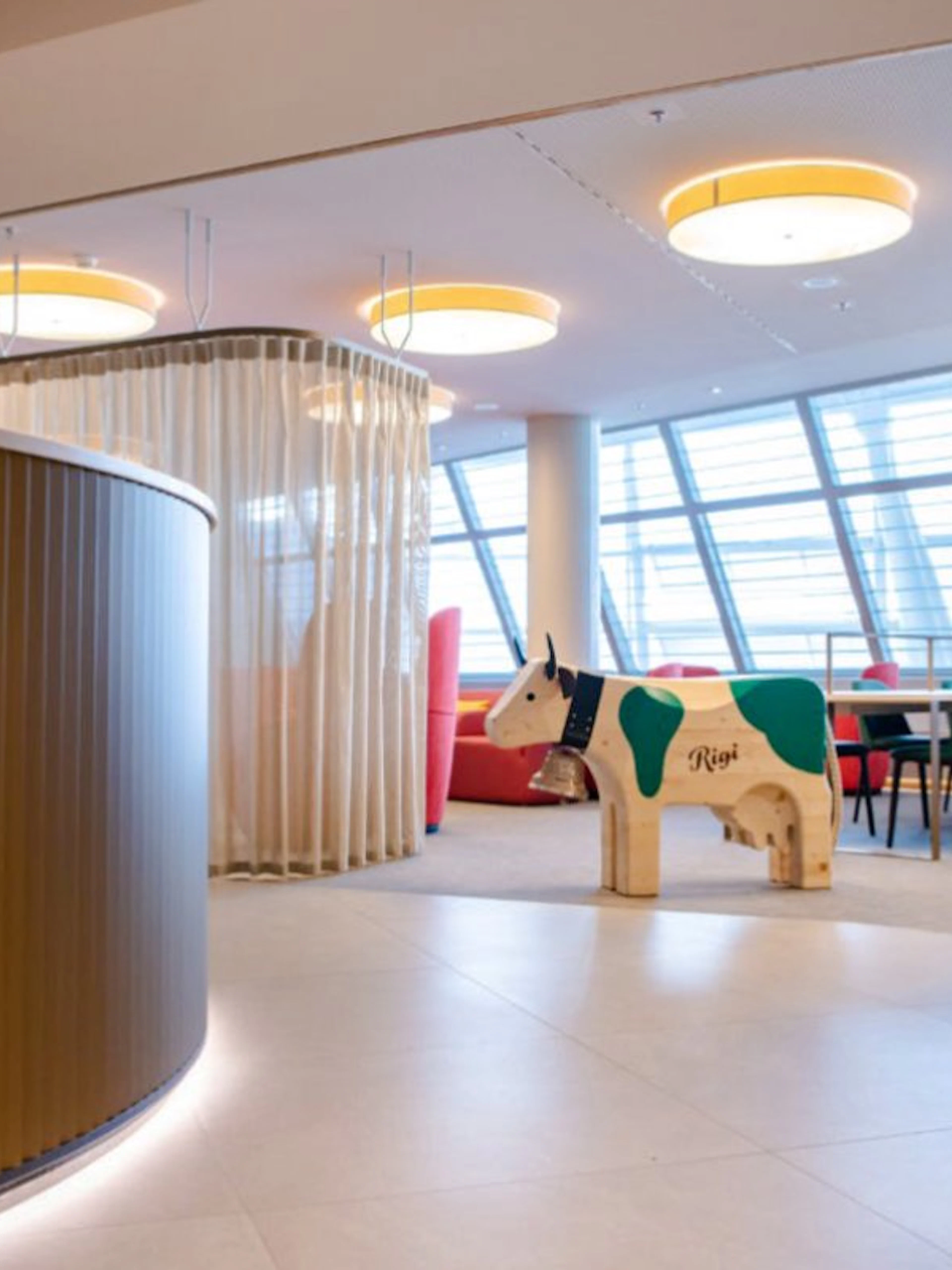 Seating area with wooden cow sculpture at Marhaba Lounge, Zurich Airport Airside Centre.