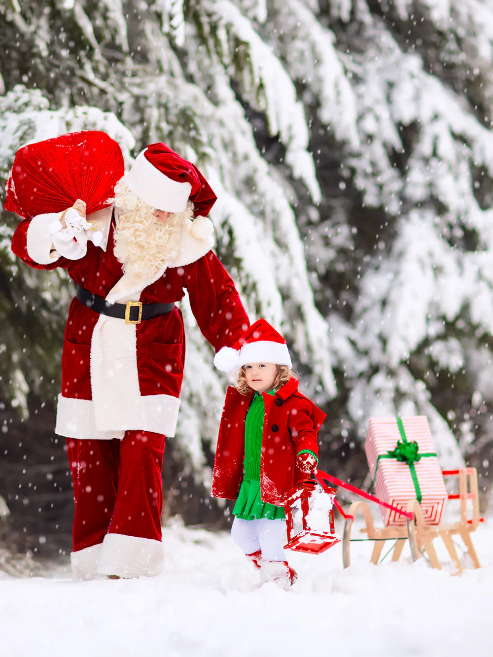 Santa and child with gifts in snowy forest.