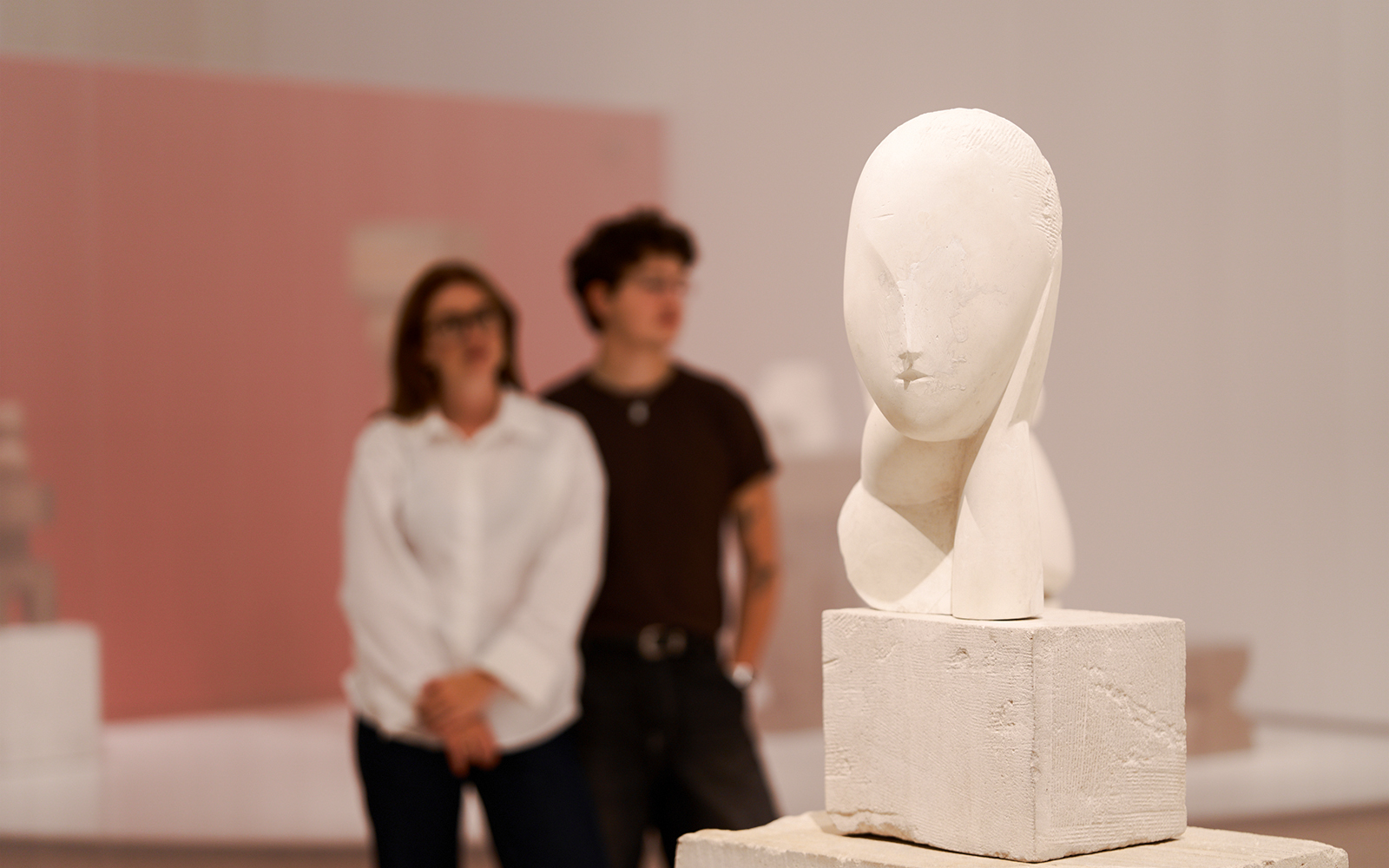 Sculpture exhibit inside the H’ART Museum with visitors observing.