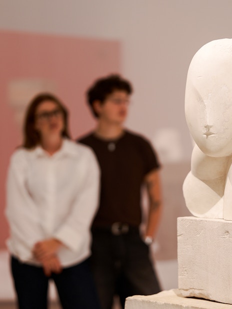 Sculpture exhibit inside the H’ART Museum with visitors observing.