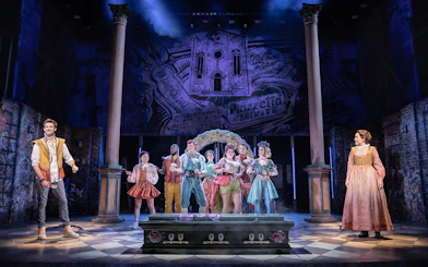 Stage performance of "& Juliet" with actors in period costumes.