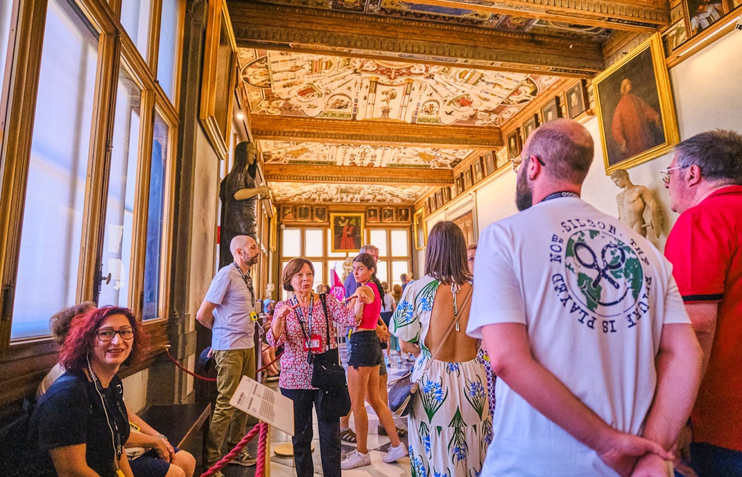 Vasari Corridor view with tourists on a private tour near Uffizi Gallery, Florence.