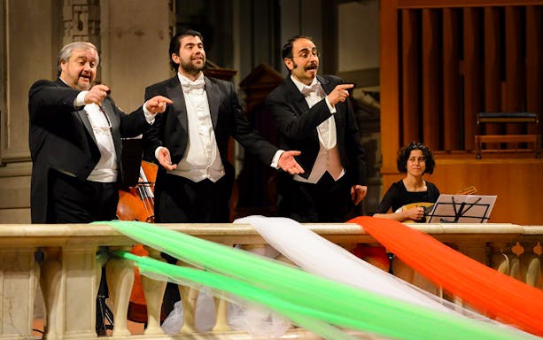 Three tenors performing with a musician in Florence during a Tuscan dinner concert.