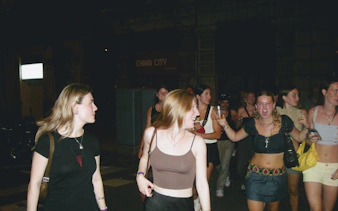 Group enjoying a night out on a Barcelona pub crawl with guided bar visits.
