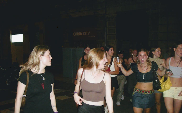 Group enjoying a night out on a Barcelona pub crawl with guided bar visits.