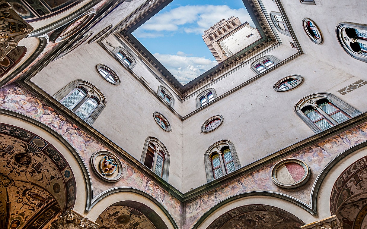 Cloister view with frescoes and tower at Palazzo Vecchio, Florence.
