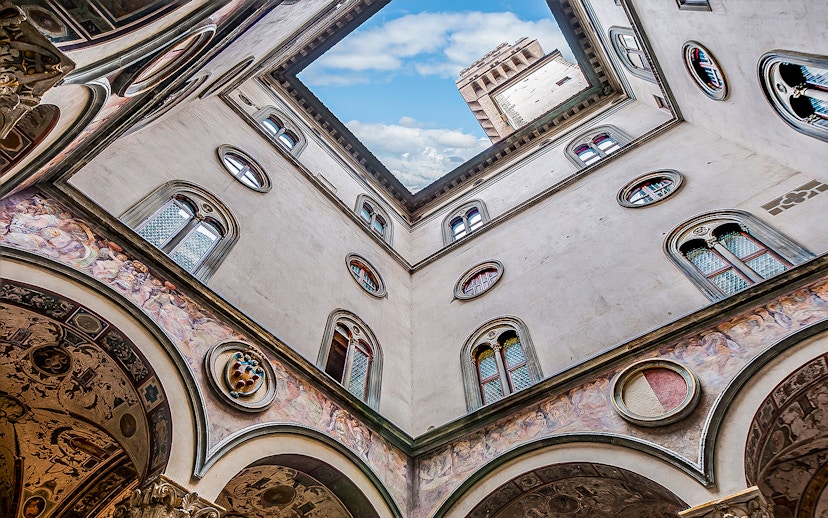 Cloister view with frescoes and tower at Palazzo Vecchio, Florence.