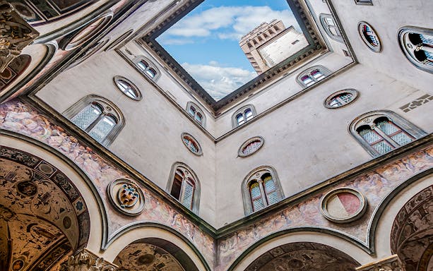 Cloister view with frescoes and tower at Palazzo Vecchio, Florence.