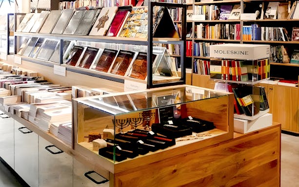 Books and souvenirs displayed at Galicia Jewish Museum gift shop in Kraków.