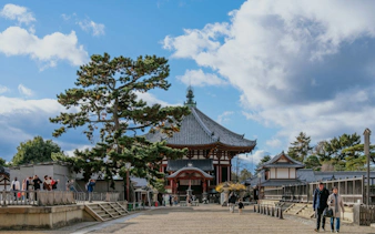 Nara temple with visitors on a UNESCO World Heritage walking tour in Japan.