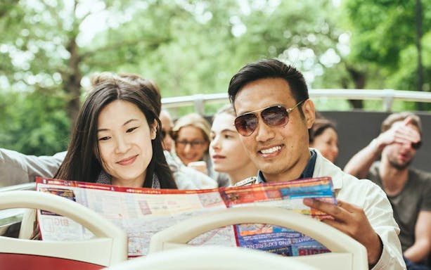 Tourists reading a map on a Big Bus London hop-on-hop-off tour.