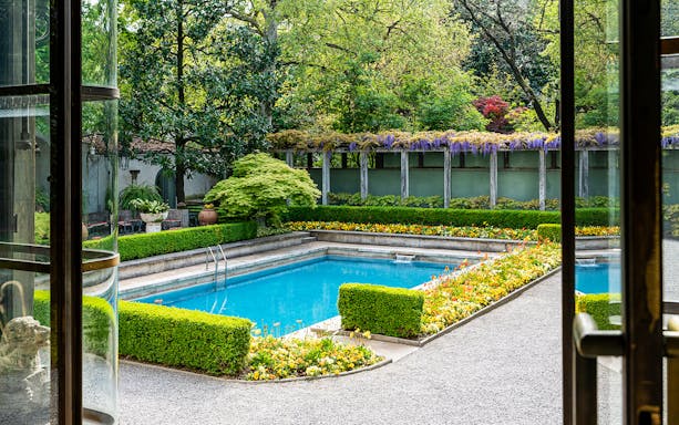 Villa Necchi Campiglio garden view with pool and lush greenery in Milan.