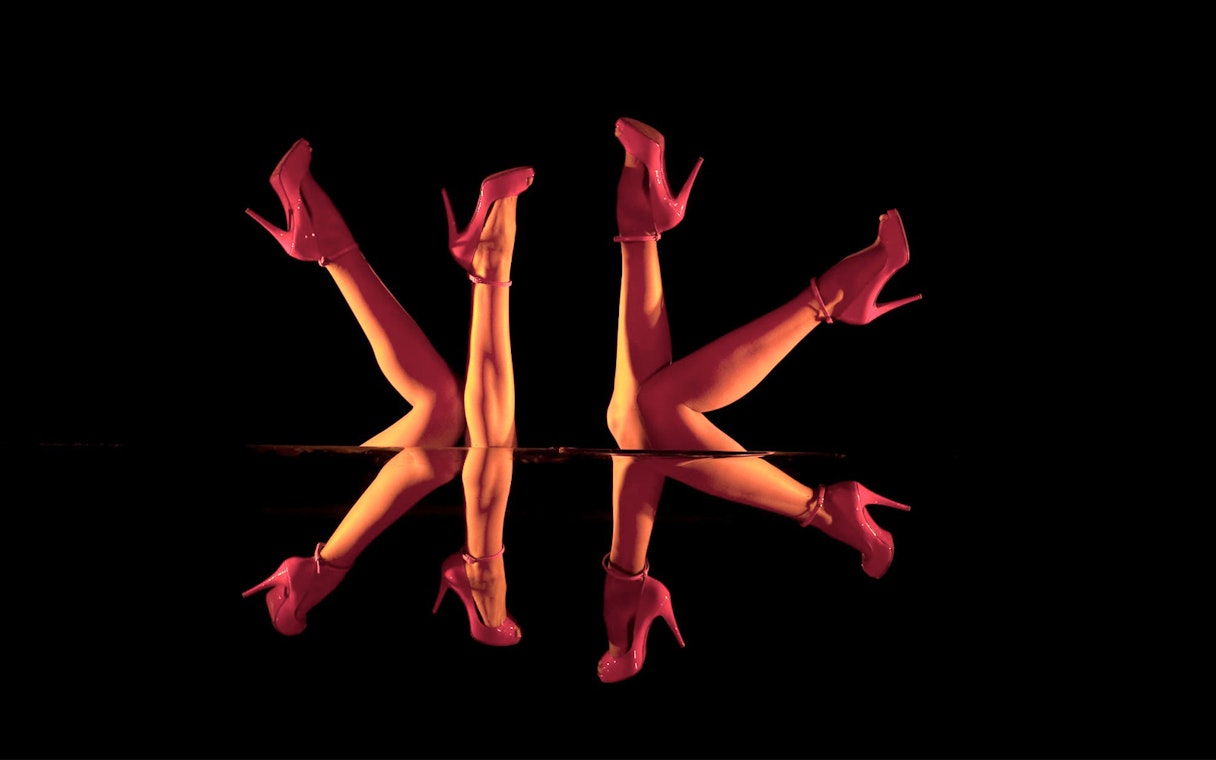Mirror reflection of dancers' legs in red heels, Crazy Horse Show, Paris.