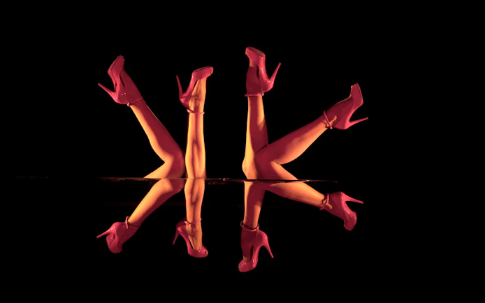 Mirror reflection of dancers' legs in red heels, Crazy Horse Show, Paris.