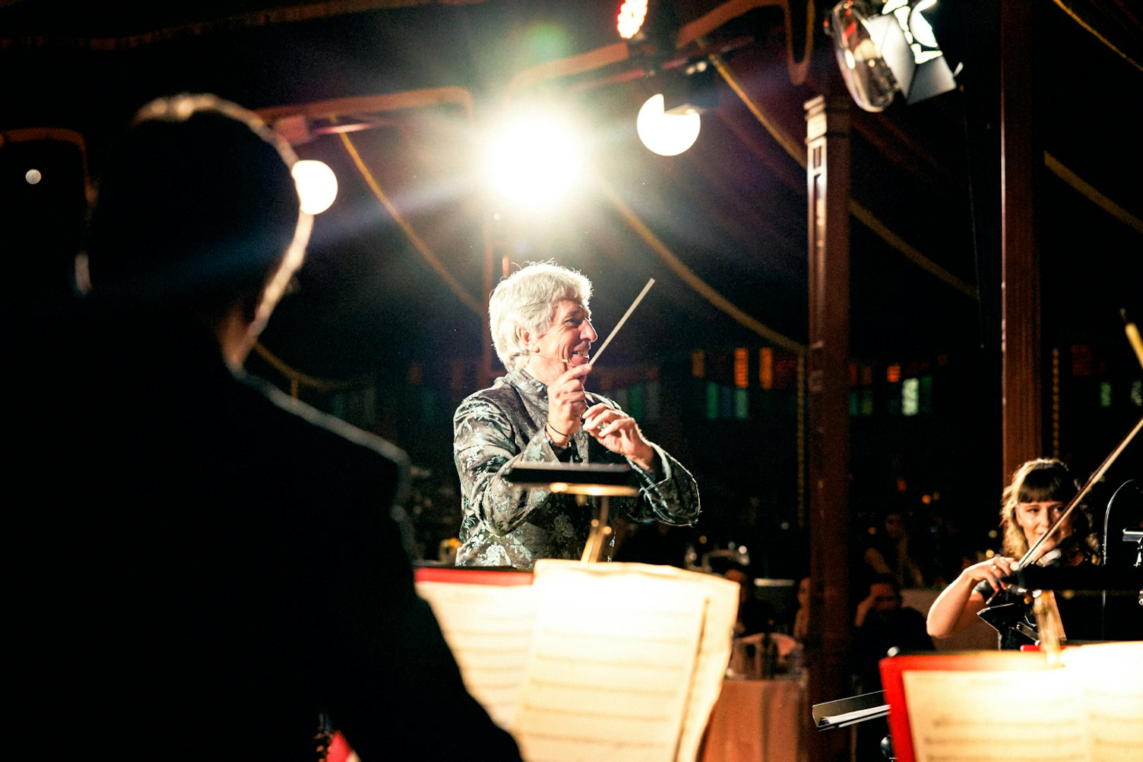 Conductor leading orchestra at Strauss concert in Prater Vienna.