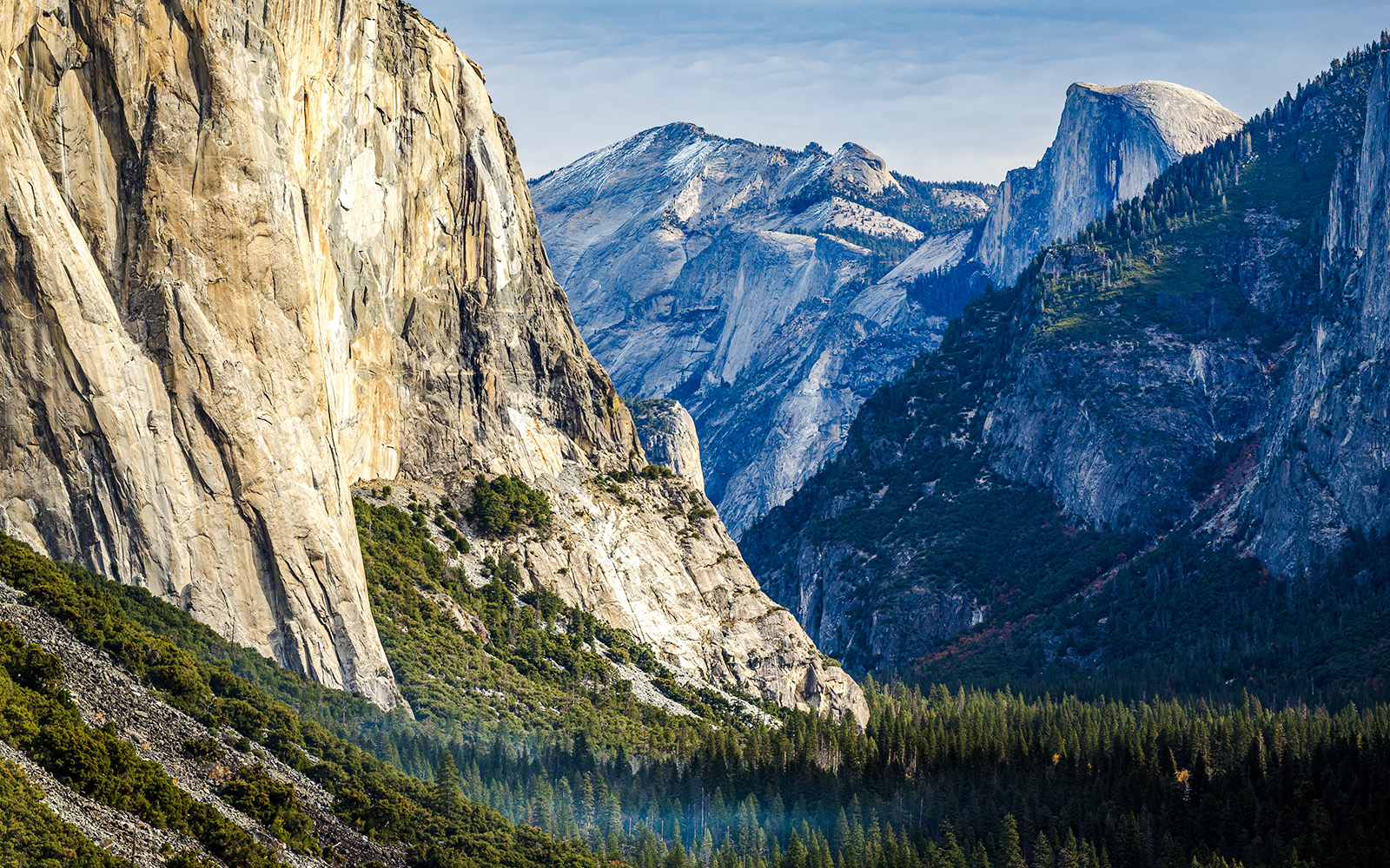 Yosemite Valley with view of Half Dome and surrounding granite cliffs.