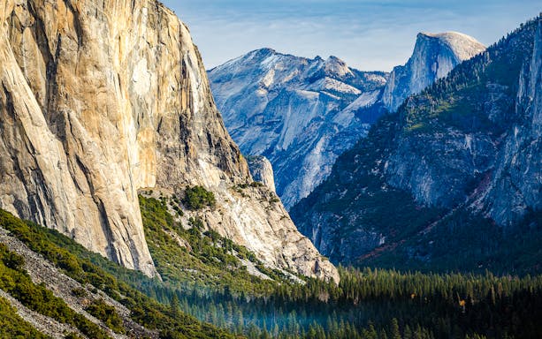 Yosemite Valley with view of Half Dome and surrounding granite cliffs.
