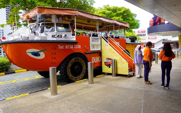 FunVee amphibious vehicle tour in Singapore with guides and tourists boarding.