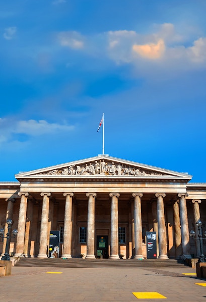 British Museum entrance with columns and sculptures, London, UK.