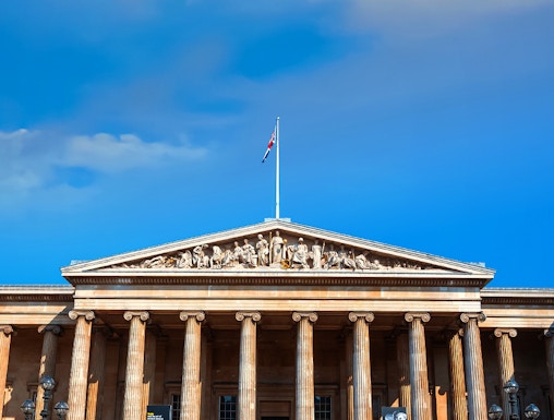 British Museum entrance with columns and sculptures, London, UK.