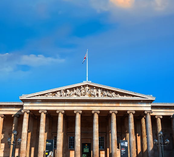 British Museum entrance with columns and sculptures, London, UK.