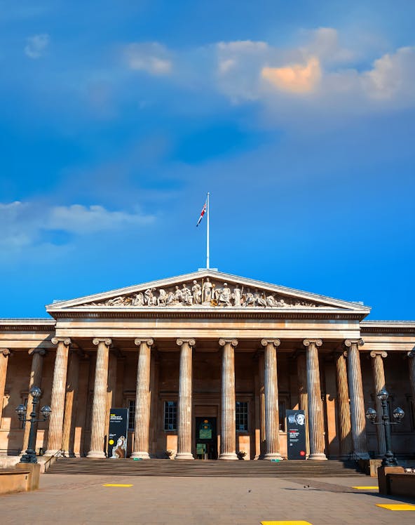 British Museum entrance with columns and sculptures, London, UK.