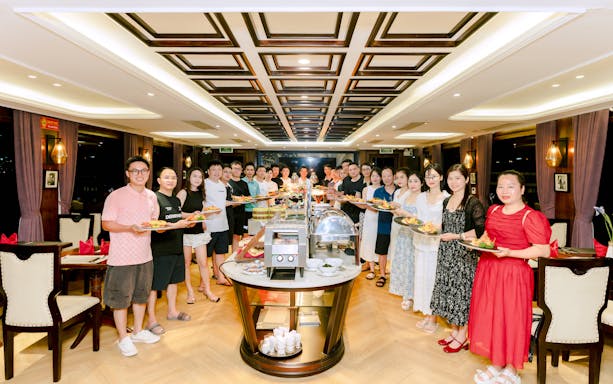 Guests enjoying dinner on the Iris Cruise with a buffet setup.