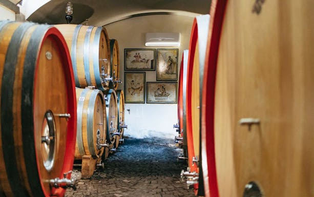 Wine barrels in a cellar during a wine tasting tour in Naples.