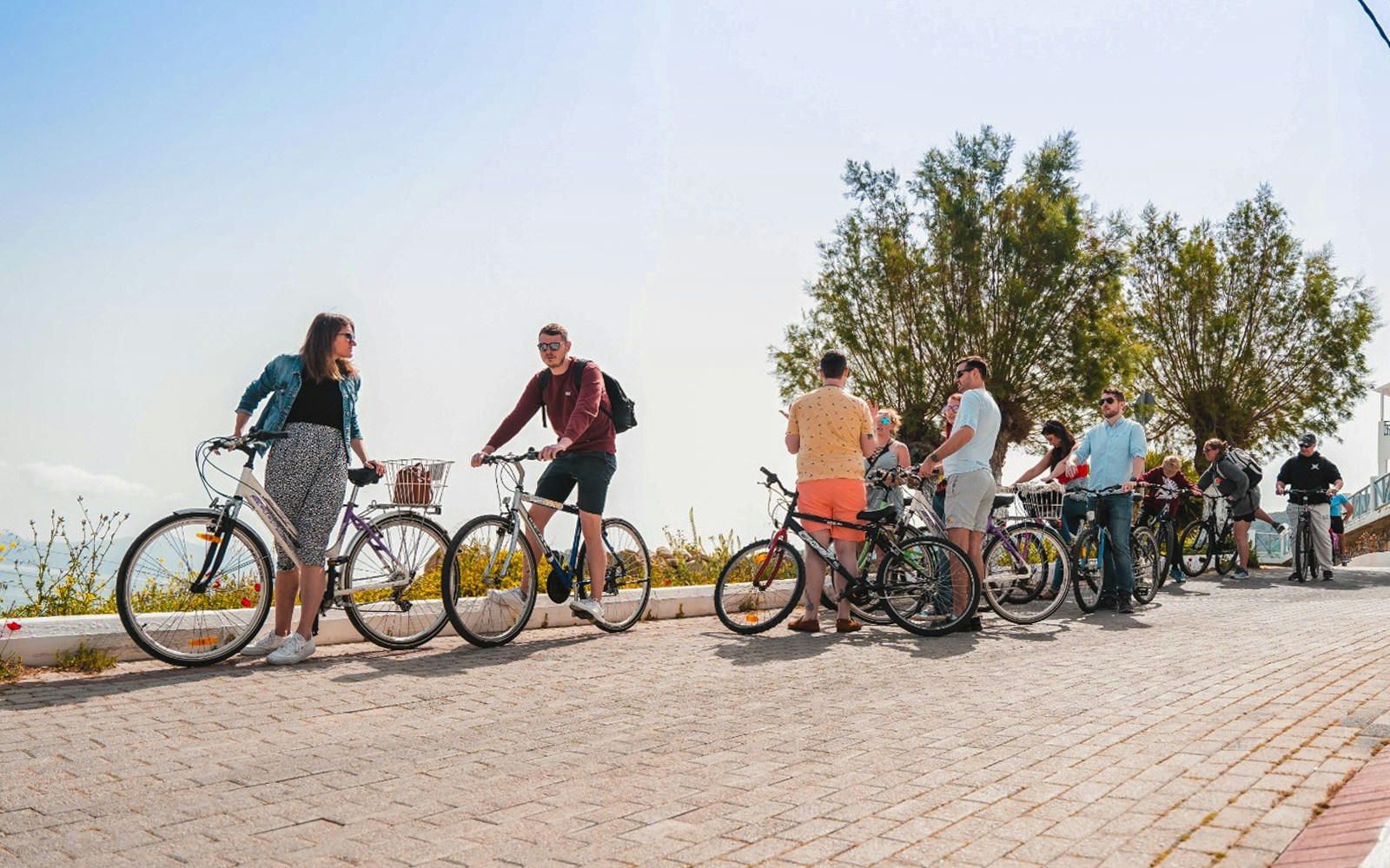 Guide explaining cycling route to tourist on Agistri Island, Greece.