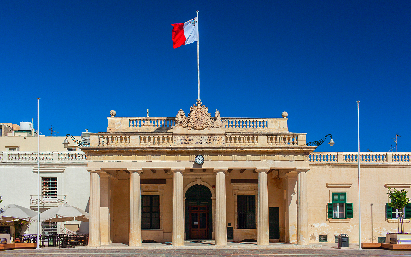 National Museum of Archeology Malta exterior with visitors exploring the historic building.