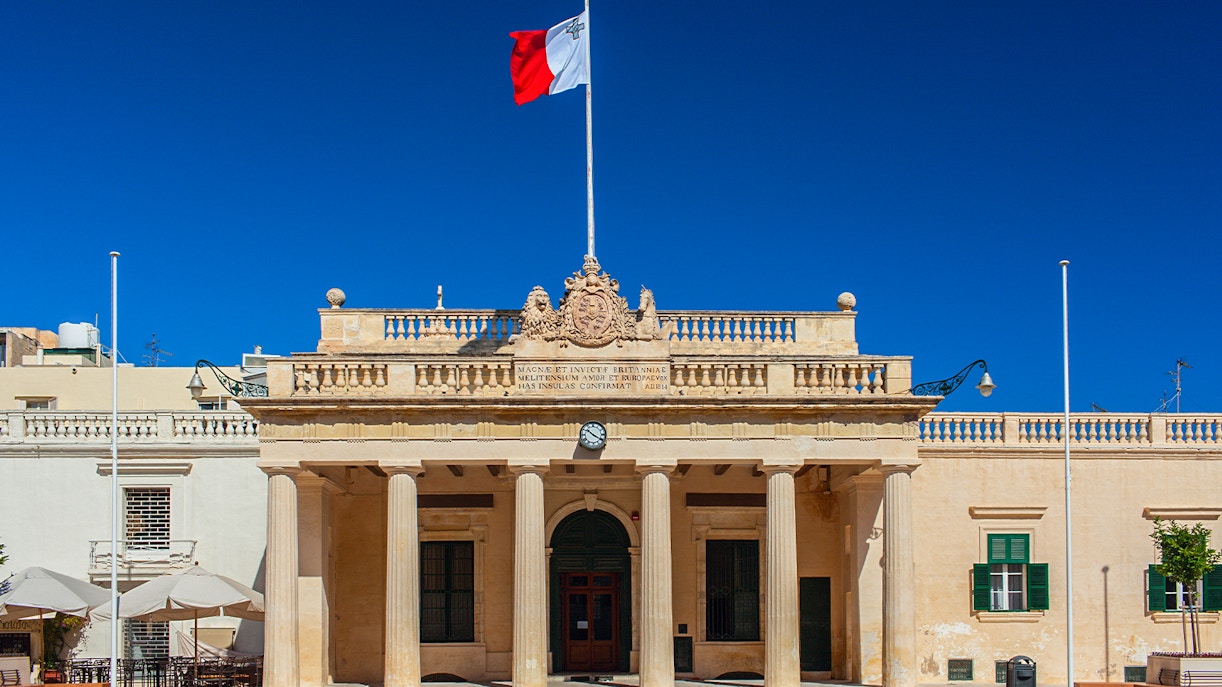 National Museum of Archeology Malta exterior with visitors exploring the historic building.