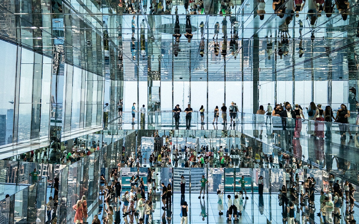 People walking on glass bridges at SUMMIT One Vanderbilt, New York City.