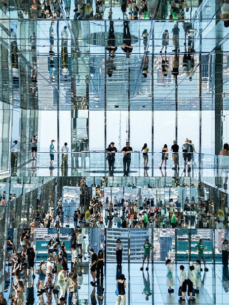 People walking on glass bridges at SUMMIT One Vanderbilt, New York City.