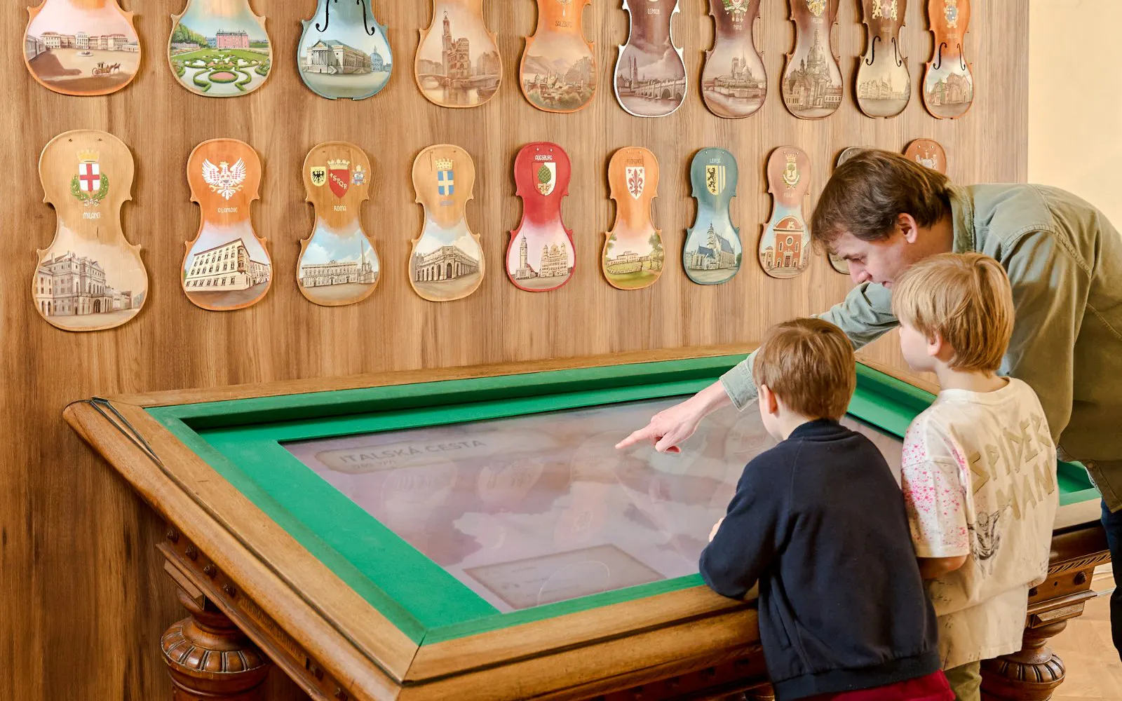 Guests interacting with a digital exhibit at Mozart Interactive Museum in Prague.