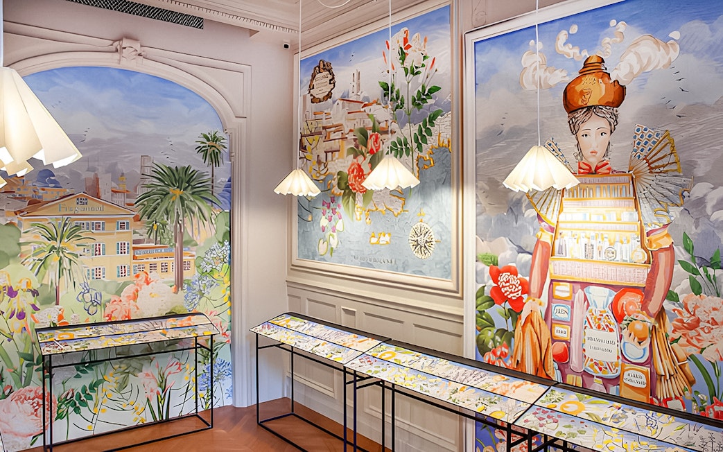 Fragonard Perfume Museum interior with colorful murals and display tables for perfume workshop.